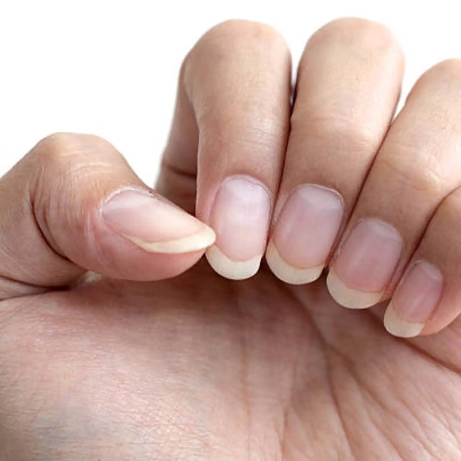 Close-up of a hand with naturally long nails, highlighting the practice of growing long nails across different cultures and time periods.