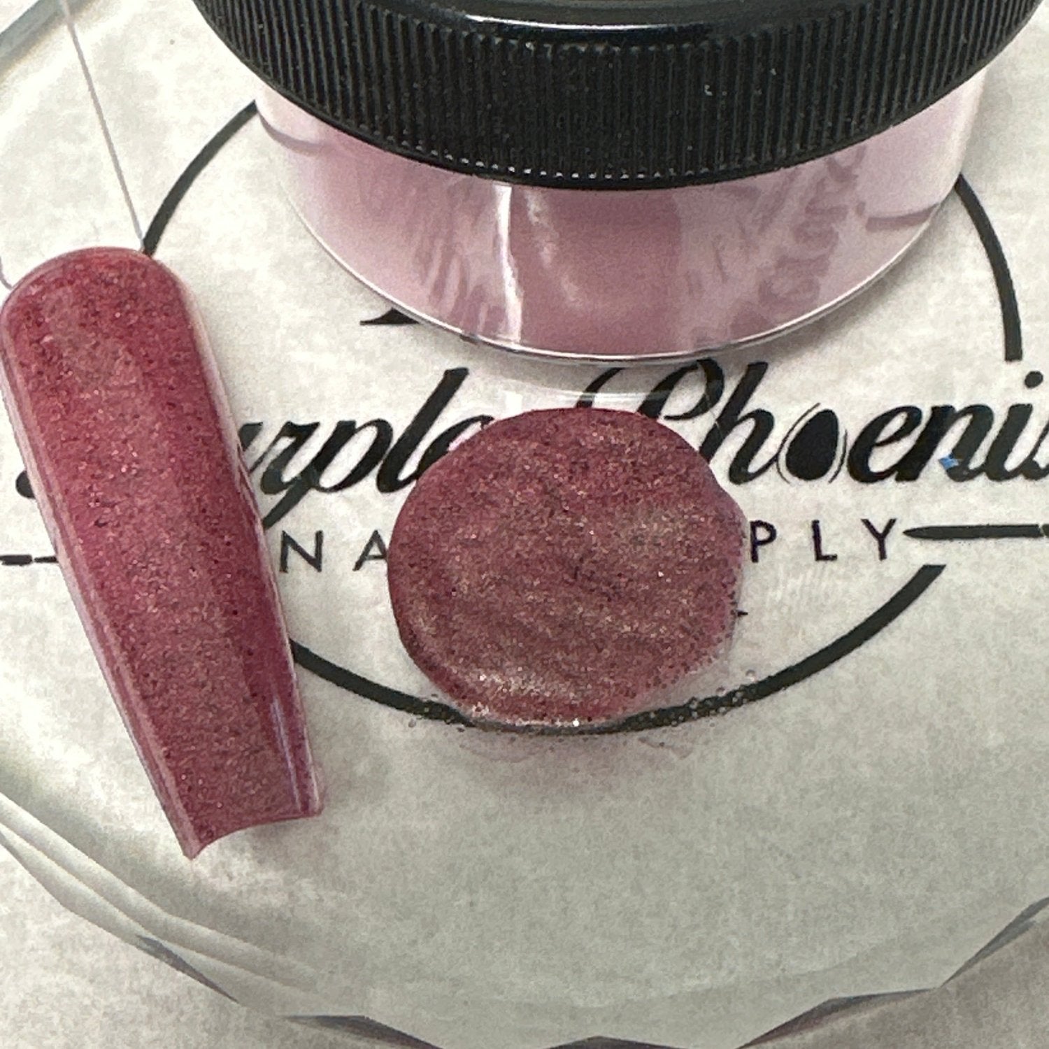 Close-up of Bewitched Rose Acrylic Powder - a deep, enchanting rose hue with a delicate shimmer, applied on a nail tip, highlighting its sophisticated and elegant finish