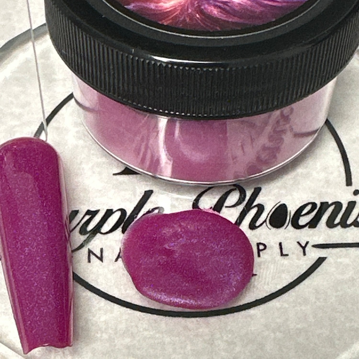 Close-up of Berry Pop Acrylic Powder - bright berry pink with subtle shimmer, applied on a nail tip, highlighting its playful and eye-catching appearance