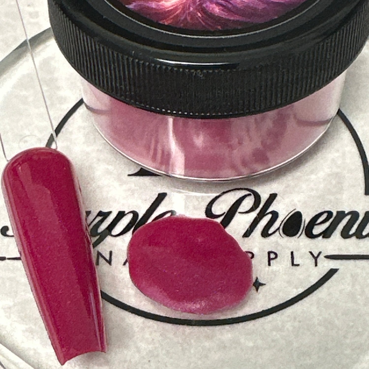 Close-up of Burgundy Bliss Acrylic Powder - dark burgundy with a smooth, elegant finish, applied on a nail tip, highlighting its refined and bold appearance.