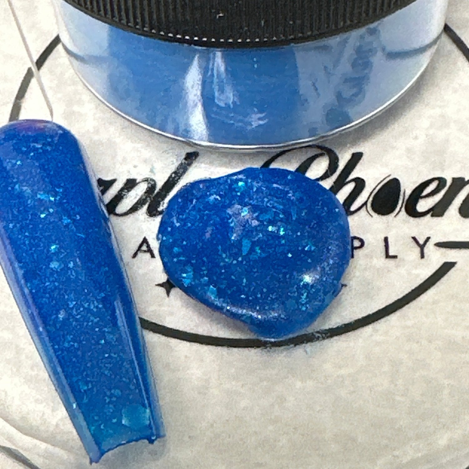 Close-up of Crystal Tide Acrylic Powder - crystal-clear with a glimmering effect, applied on a nail tip, highlighting its delicate, reflective sheen reminiscent of ocean waves.