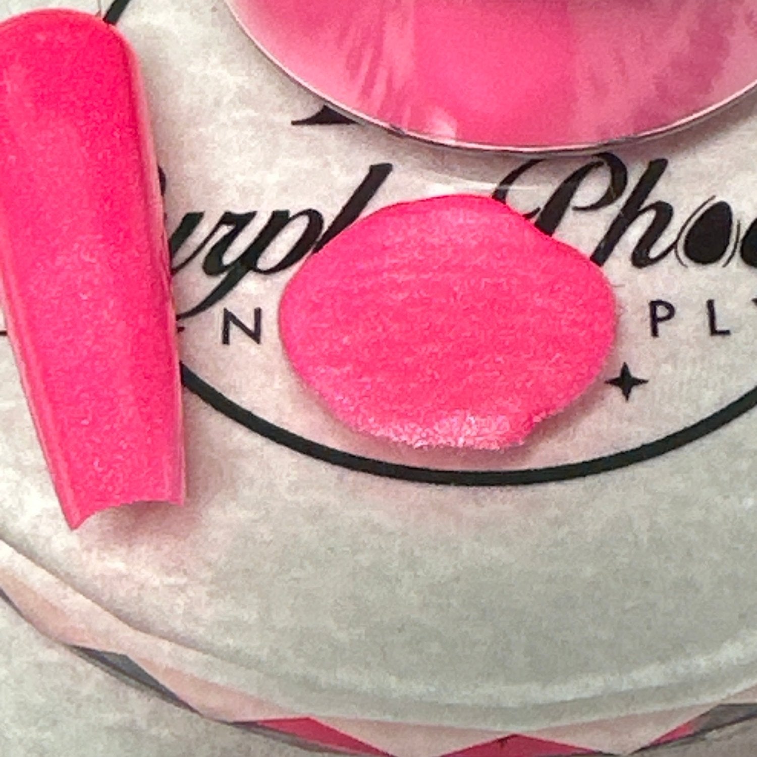 Close-up of Flashy Flamingo Acrylic Powder - bright neon pink with a soft shimmer, applied on a nail tip, highlighting its lively, playful appearance.