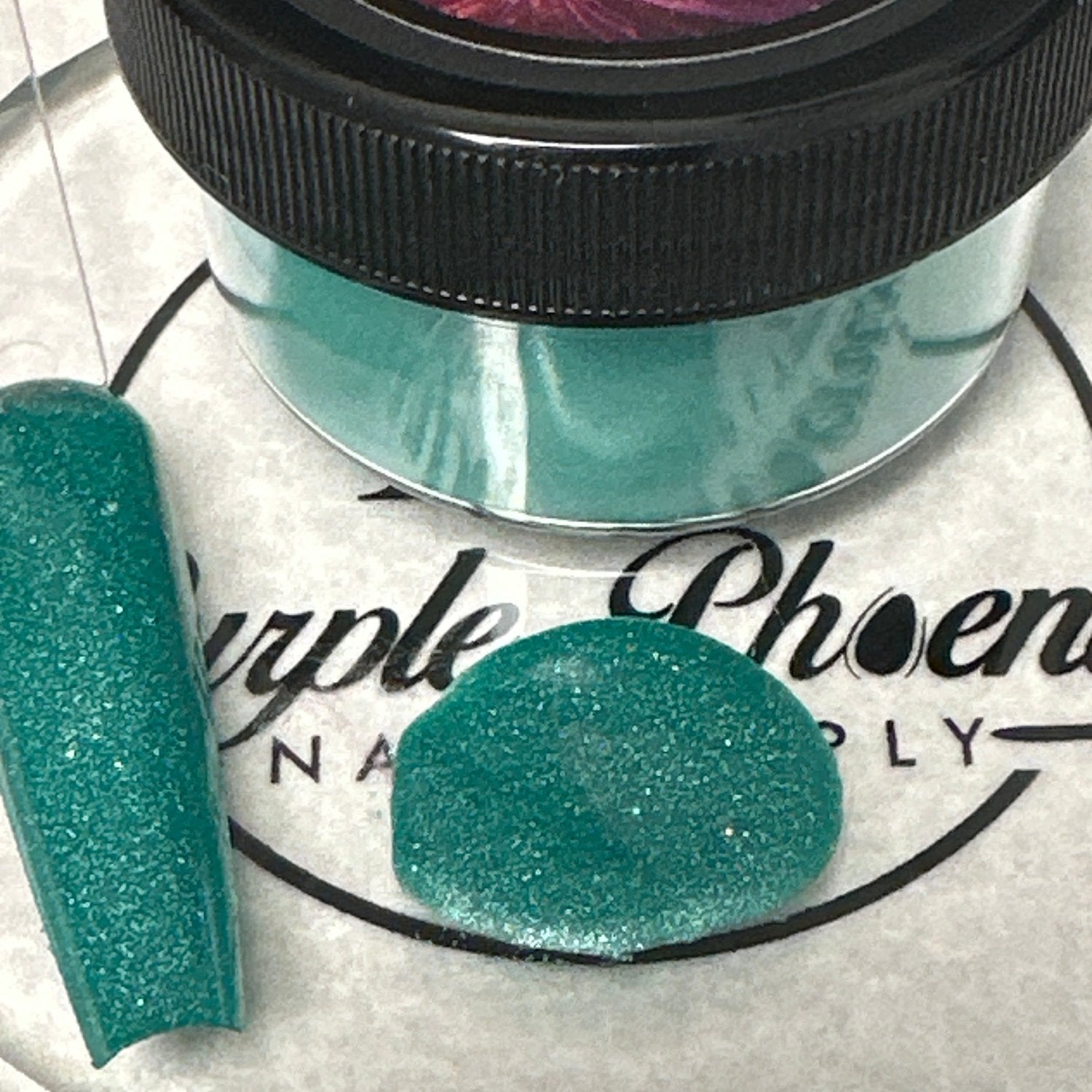 Swatch of Glowing Goblin Acrylic Powder - a vibrant green shade with a glowing effect, applied on a nail tip, showcasing its bold and luminous finish