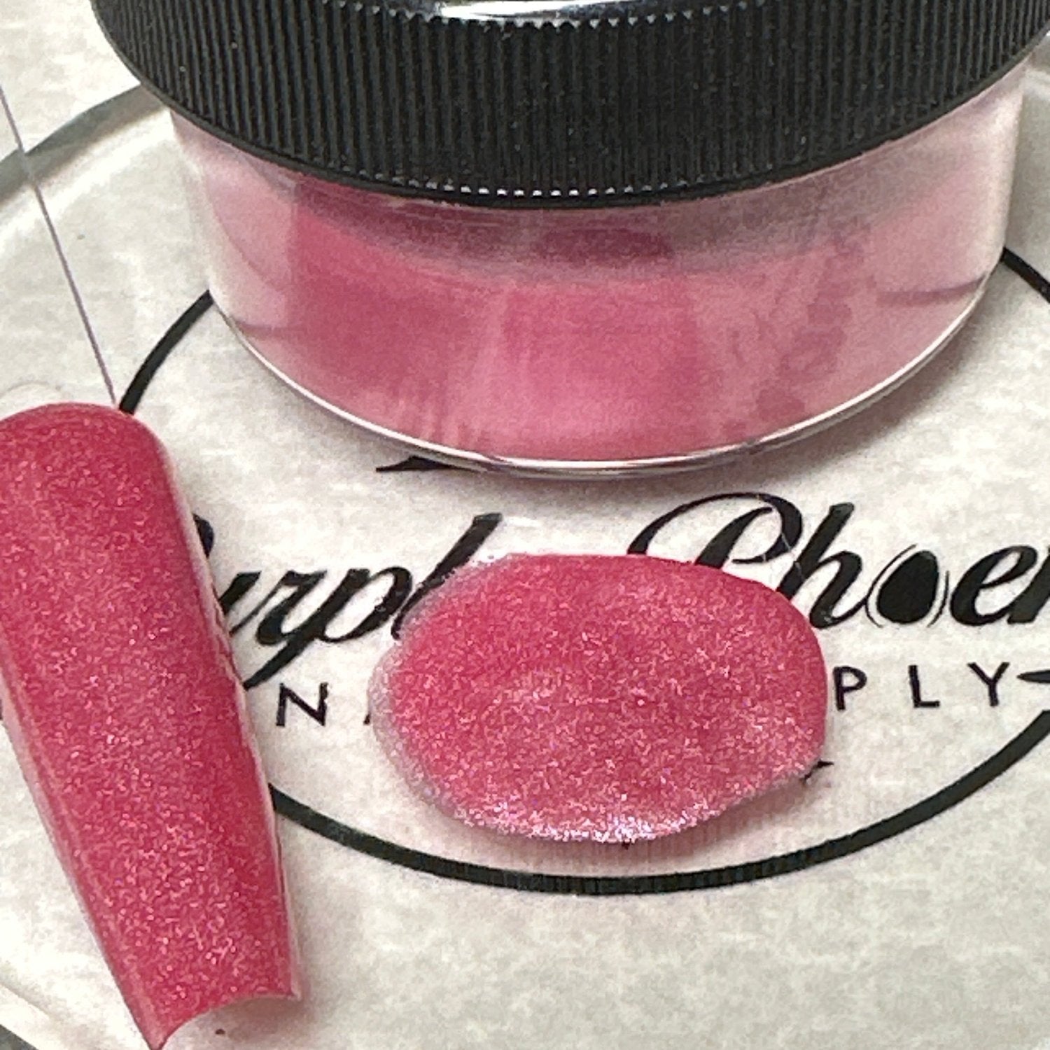 Close-up of Hibiscus Blush Acrylic Powder - bright tropical pink with a soft glow, applied on a nail tip, highlighting its lively and cheerful appearance