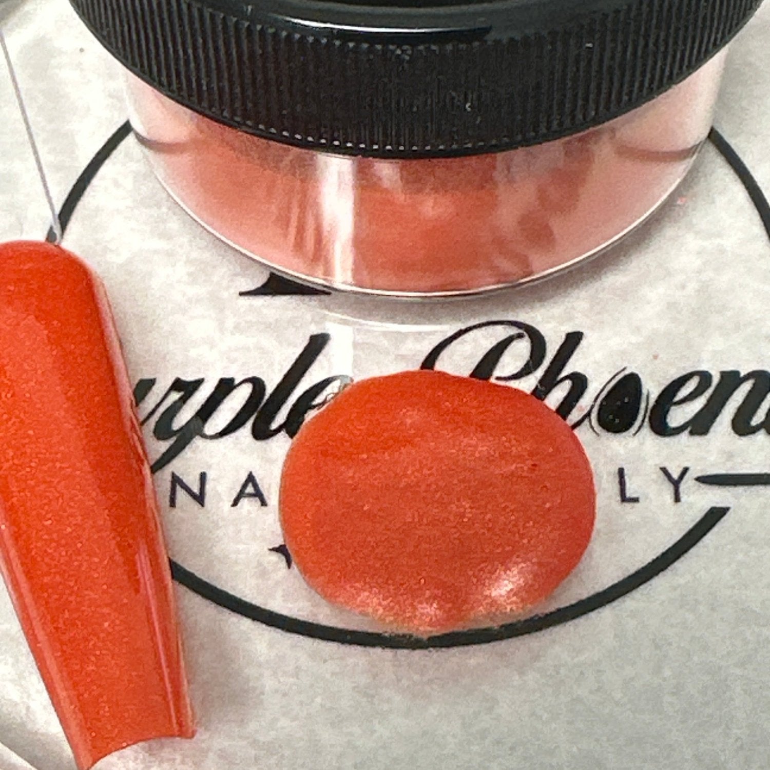 Close-up of Fiery Pumpkin Acrylic Powder - bright orange with a soft shimmer, applied on a nail tip, highlighting its glowing, autumn-inspired appearance.