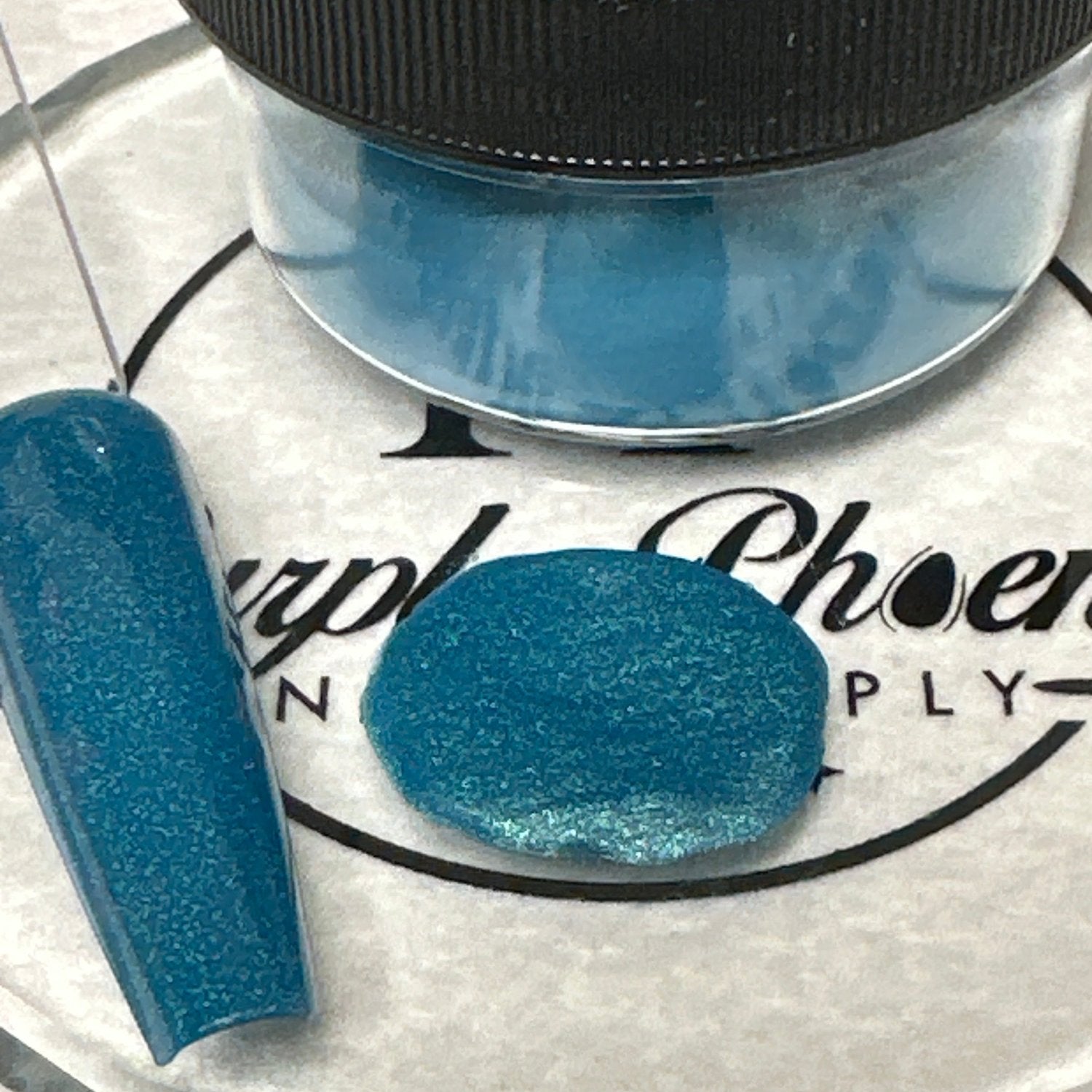 Swatch of Tidal Teal Acrylic Powder - a vibrant teal shade with a subtle shimmer, applied on a nail tip, showcasing its rich, ocean-inspired finish.