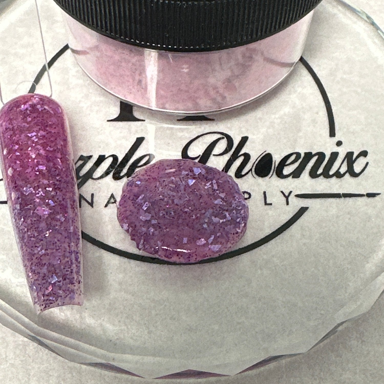 Close-up of Vampire Violet Acrylic Powder - deep purple with shimmering iridescent glitter, applied on a nail tip, highlighting its enchanting and bold appearance.