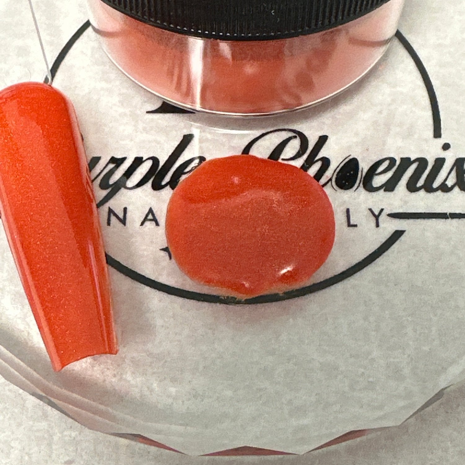 Swatch of Fiery Pumpkin Acrylic Powder - a vibrant orange shade with a subtle shimmer, applied on a nail tip, showcasing its bold, warm tone and smooth finish