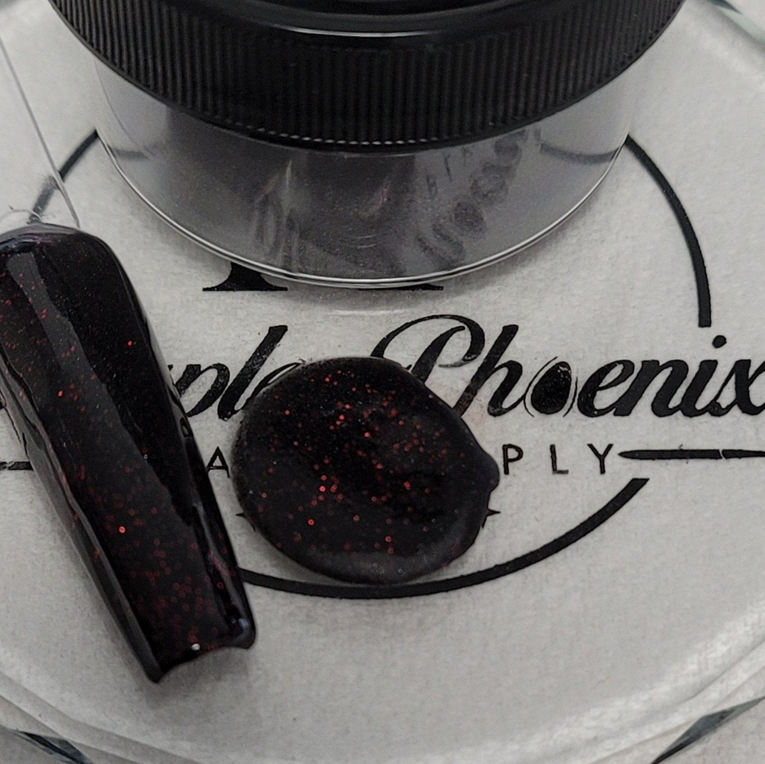 1 oz jar of Scarlet Moon Acrylic Powder, featuring a mystical red shimmer and black base