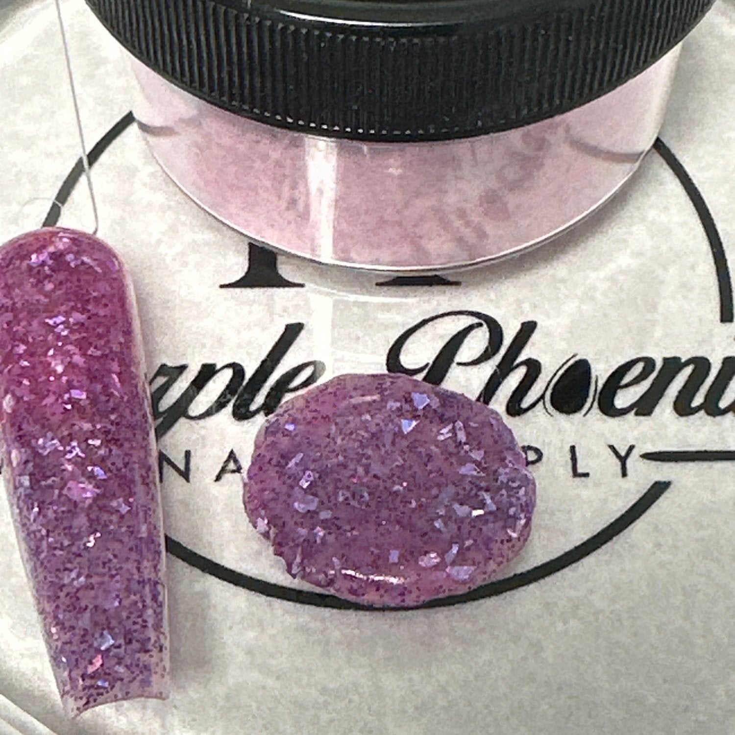 Swatch of Vampire Violet Acrylic Powder - a dark purple shade with iridescent glitter, applied on a nail tip, showcasing its rich, mystical finish.